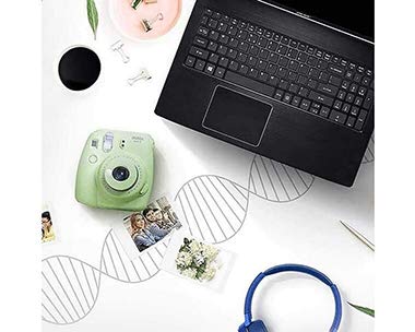 A laptop and a Old camera on desk